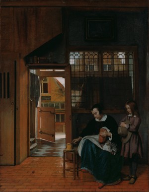 A woman preparing bread and butter for a boy